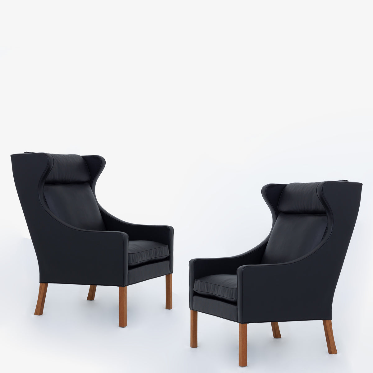 BM 2204 - A pair of Wingback Chairs in black leather