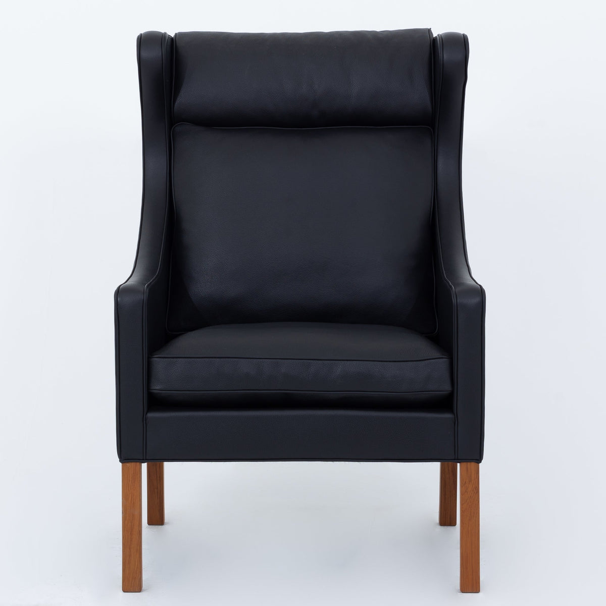 BM 2204 - A pair of Wingback Chairs in black leather