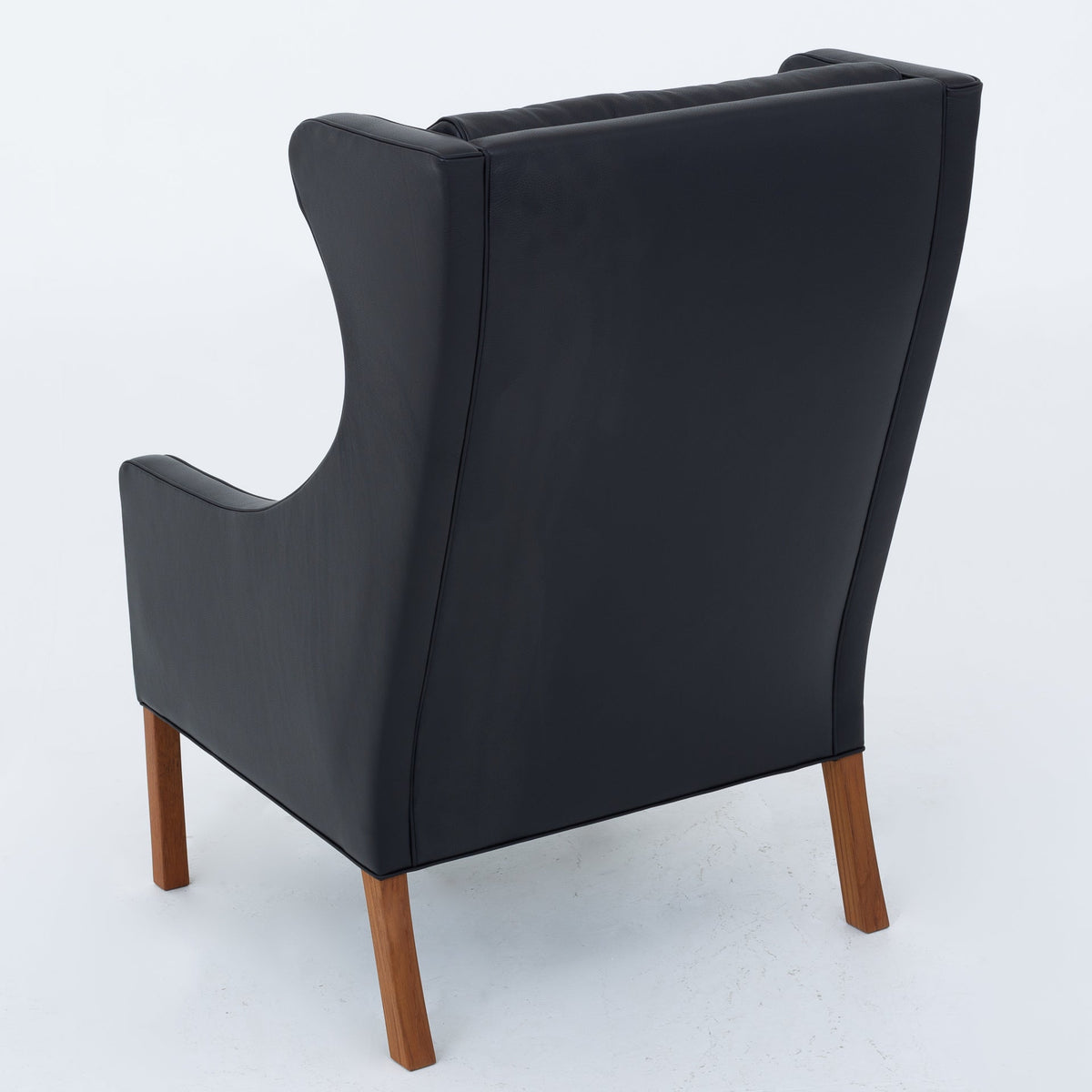 BM 2204 - A pair of Wingback Chairs in black leather